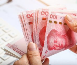 a-person-counting-chinese-renminbi-bills