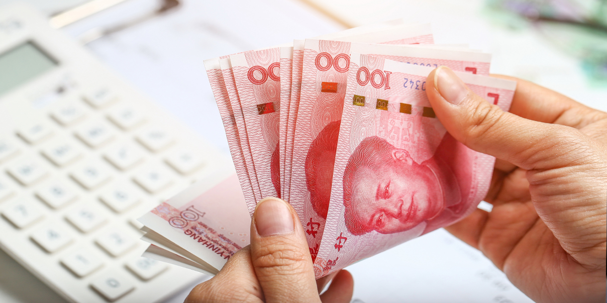 a-person-counting-chinese-renminbi-bills